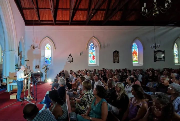 J.-M.-Coetzee-reading-to-the-packed-church-credit-Erica-Lombard-scaled-1